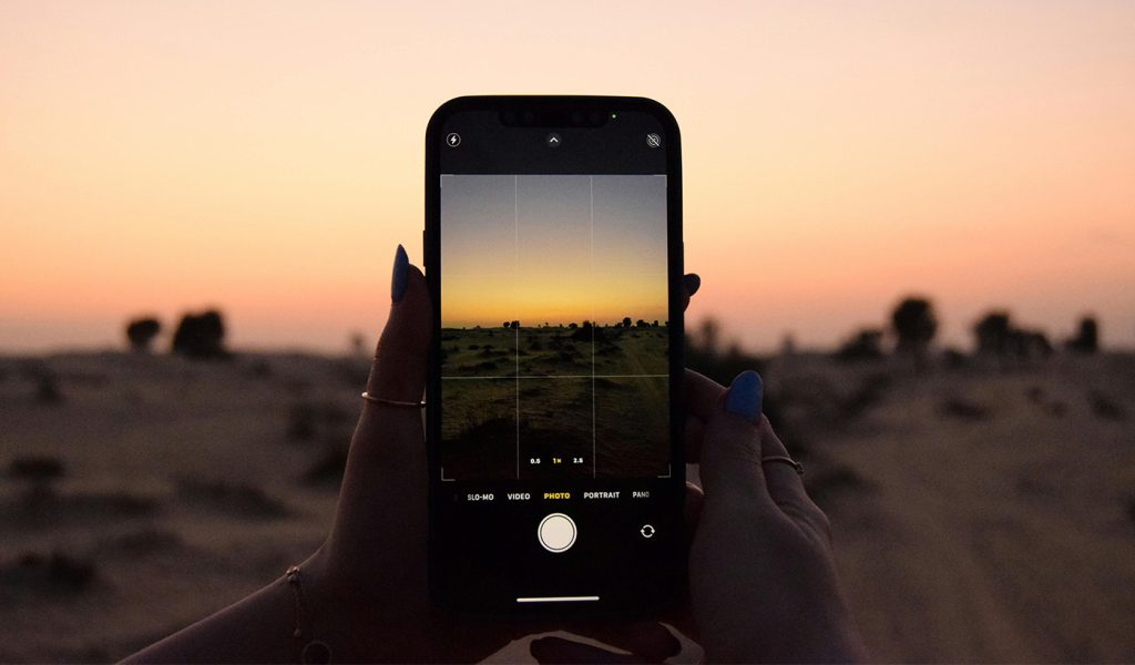 Sunset getting photographed on a mobile phone. Photographer is shooting in the golden hour