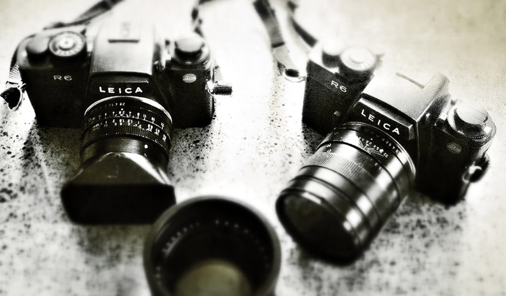 Two Leica cameras and a lens