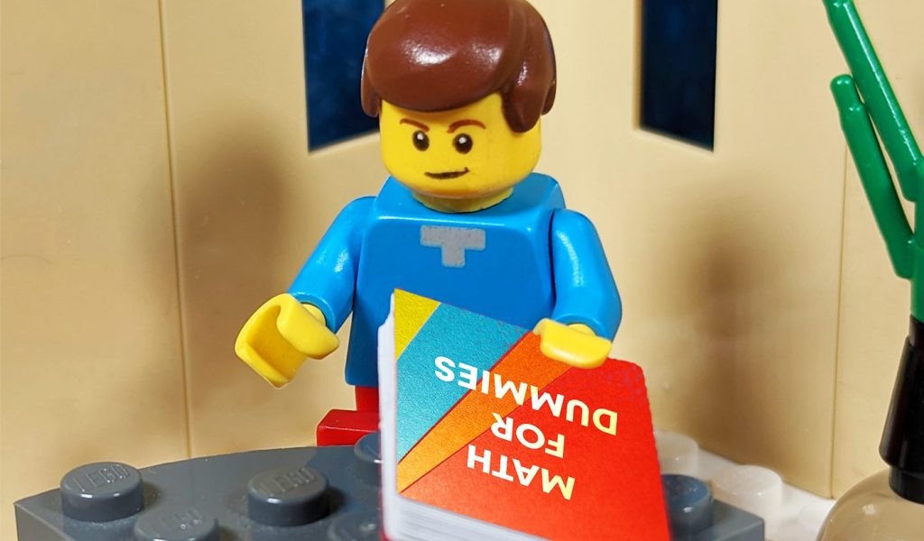 Lego figure holding a tiny book