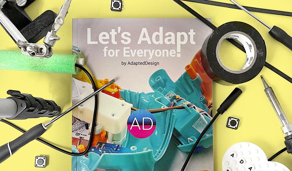 cover of the self published book 'Let's Adapt for Everyone!' by Greg Nakata surrounded by common tools used in adapted design