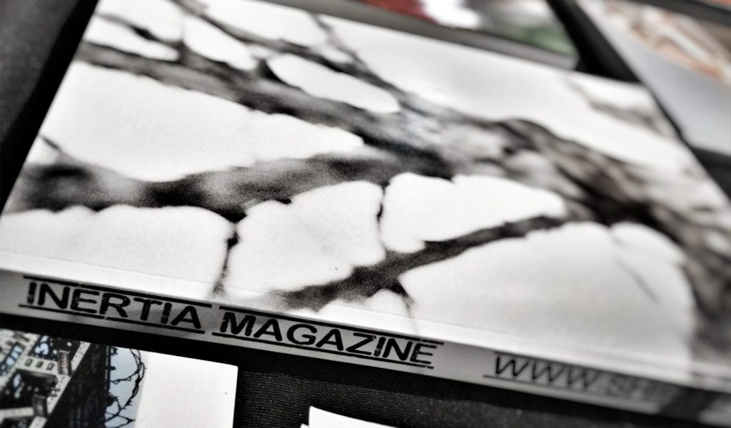 photo of book cover for Intertia Magazine suggesting its freshly printed and ready to sell to target audience