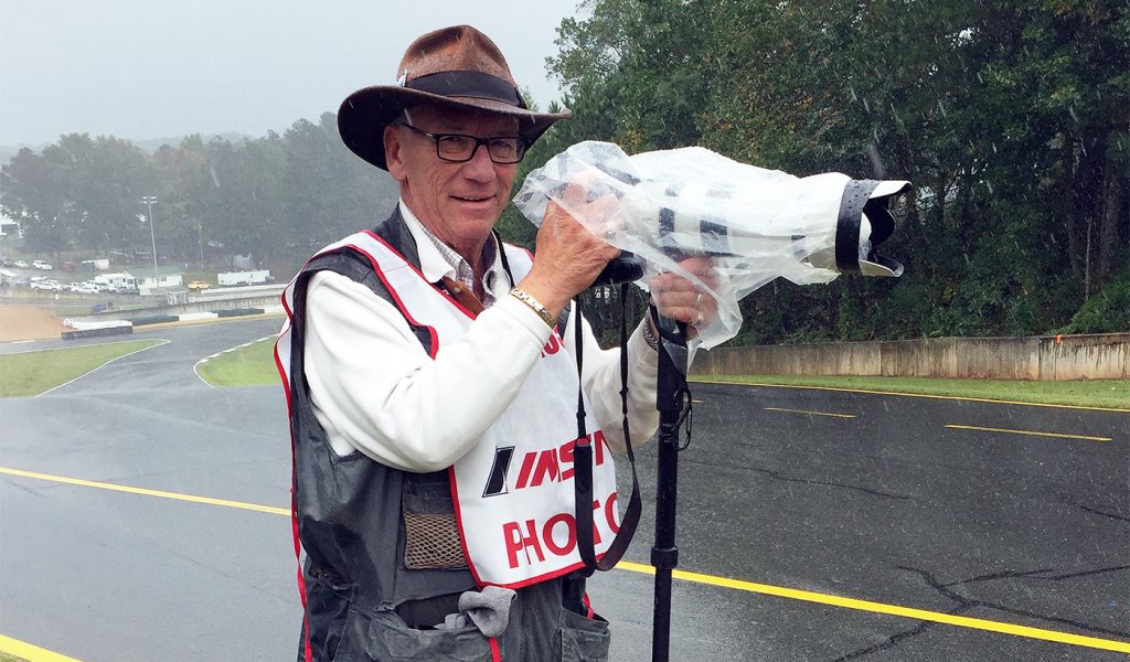 photo of self published photo book author Jack Webster photographing an auto race