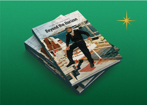 A stack of paperback books titled 'Beyond the Horizon' featuring a cover photo of an older sailor standing confidently on a ship deck, with the sea and harbor in the background. 