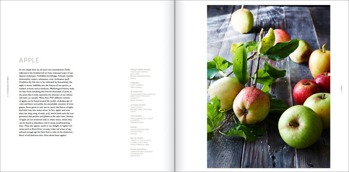 Open pages from 'The Essence of Wine' showing text on one side and apples on the other